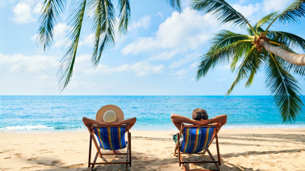 two green gecko clients relaxing by the beach as a result of the multi day island hopping tour