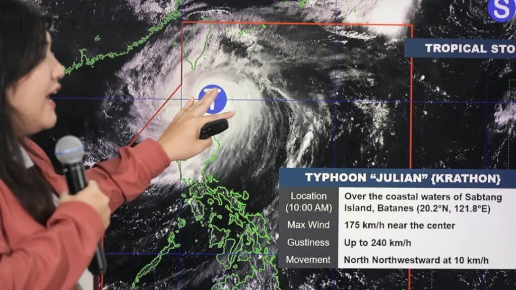 typhoon in the philippines woman pointing at a weather map